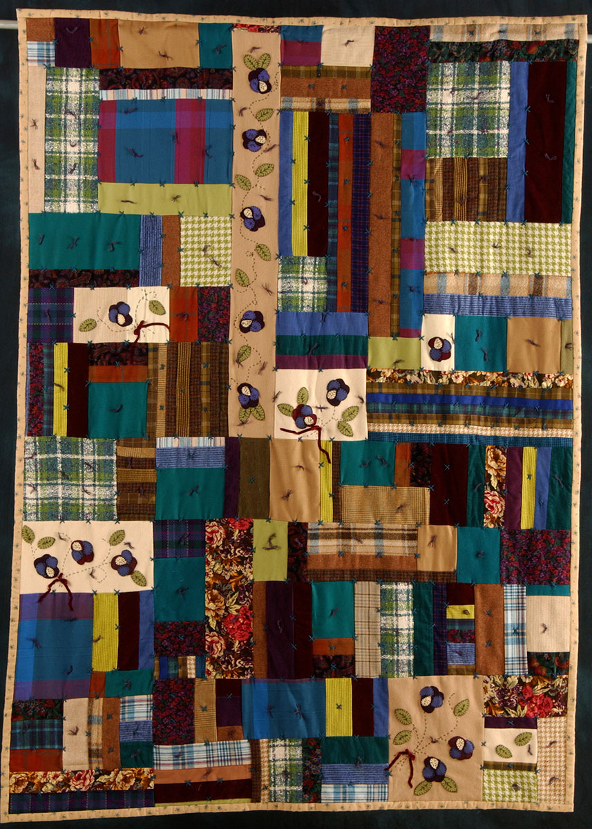 A memorial quilt by Celebration Quilters featuring blueberry print and olive green gingham.