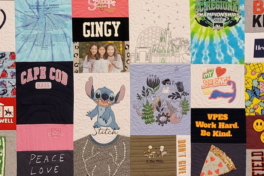 A colorful t-shirt quilt featuring Disney's Stitch character and pinks/purples/tie-dye.